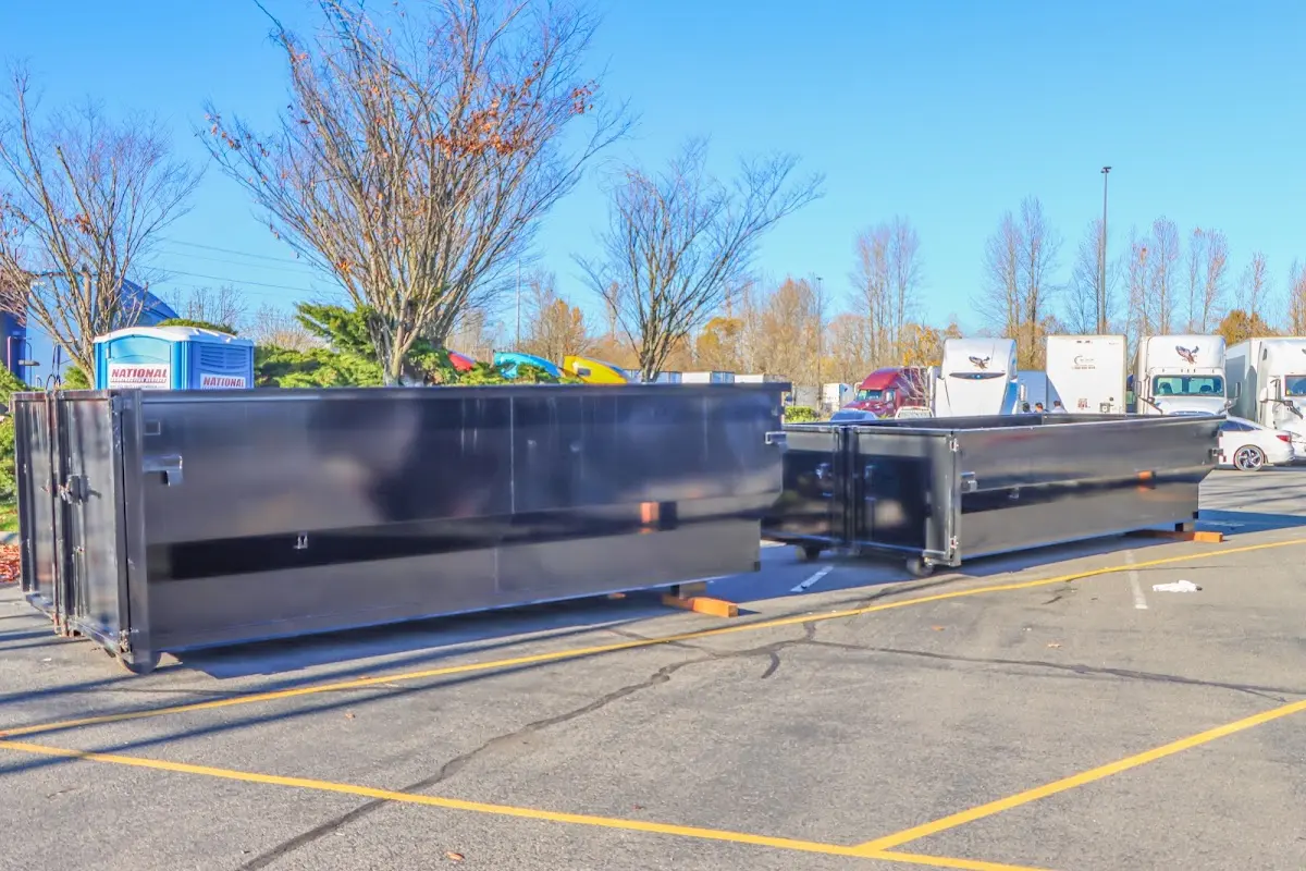 Professional dumpster rental service with roll-off container on residential driveway in Hanover Park
